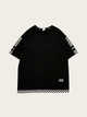 Black t-shirt with checkered sleeves and bottom on a light beige background