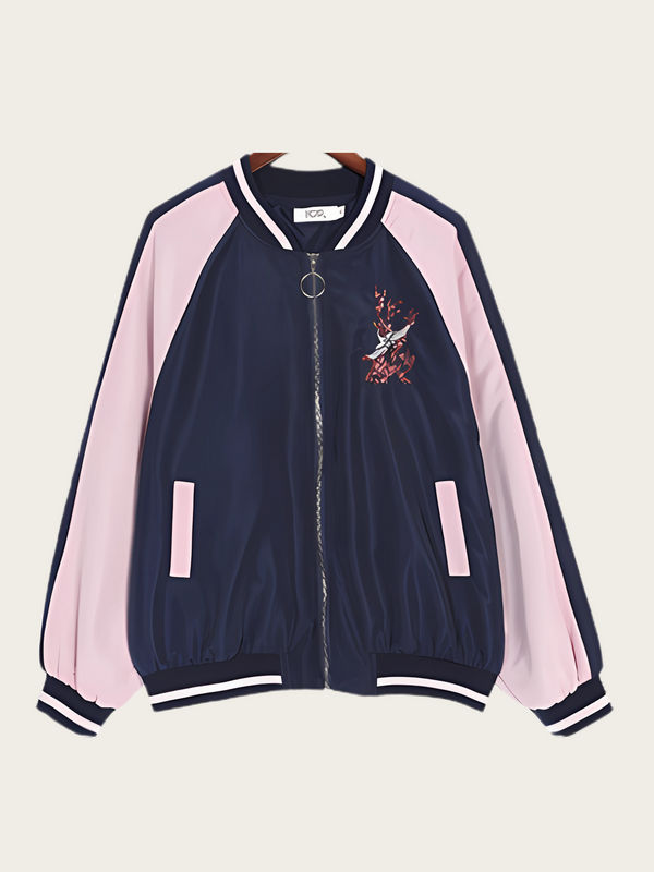 Navy and pink bomber jacket with embroidery on a beige background