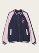 Navy and pink bomber jacket with embroidery on a beige background