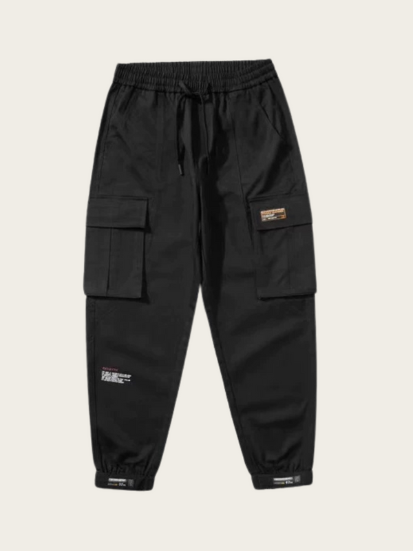 Black cargo pants with multiple pockets on a beige background