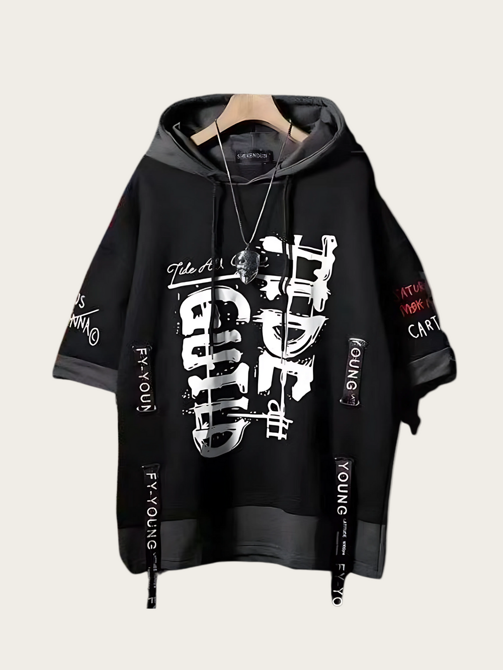 Black hoodie with white graphics and text on a beige background