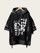 Black hoodie with white graphics and text on a beige background