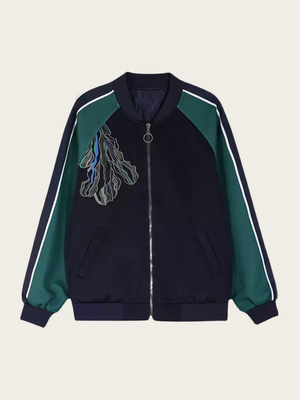 Black and green jacket with a design on the chest against a beige background