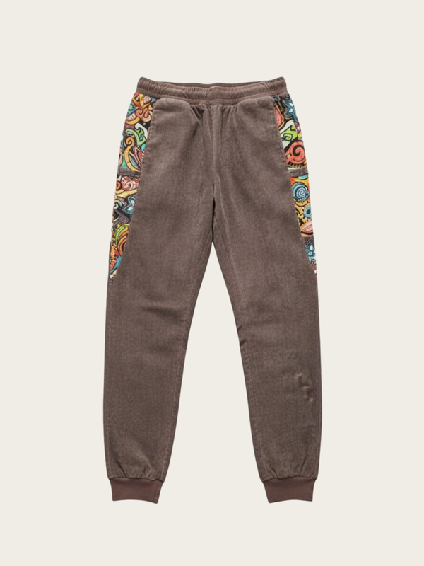 Brown sweatpants with colorful patterns on the sides on a beige background