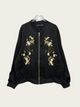 Black bomber jacket with floral embroidery on a white background