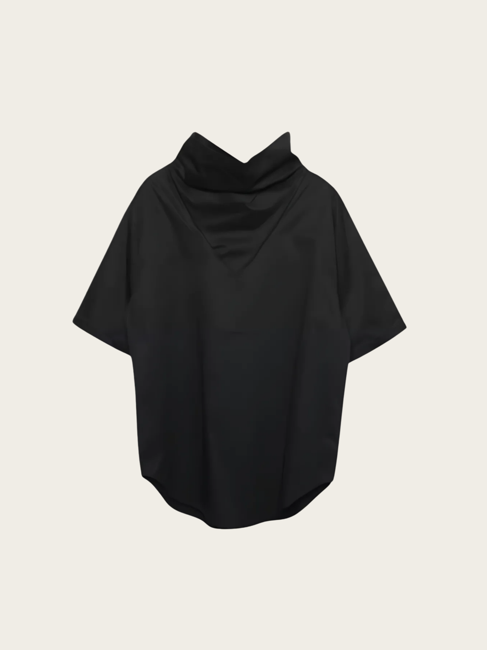 Black poncho on a beige background