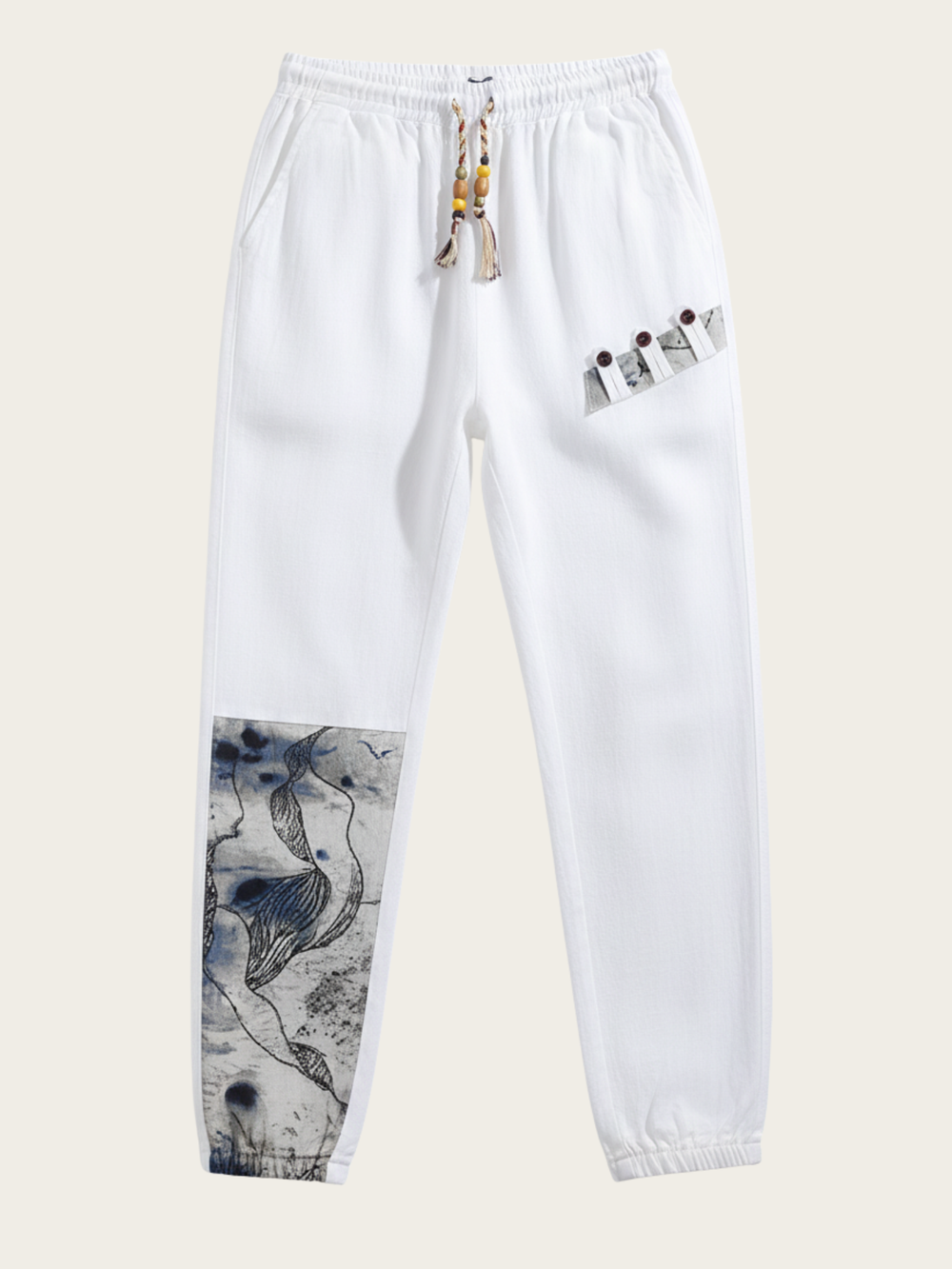 White pants with abstract designs on a light beige background