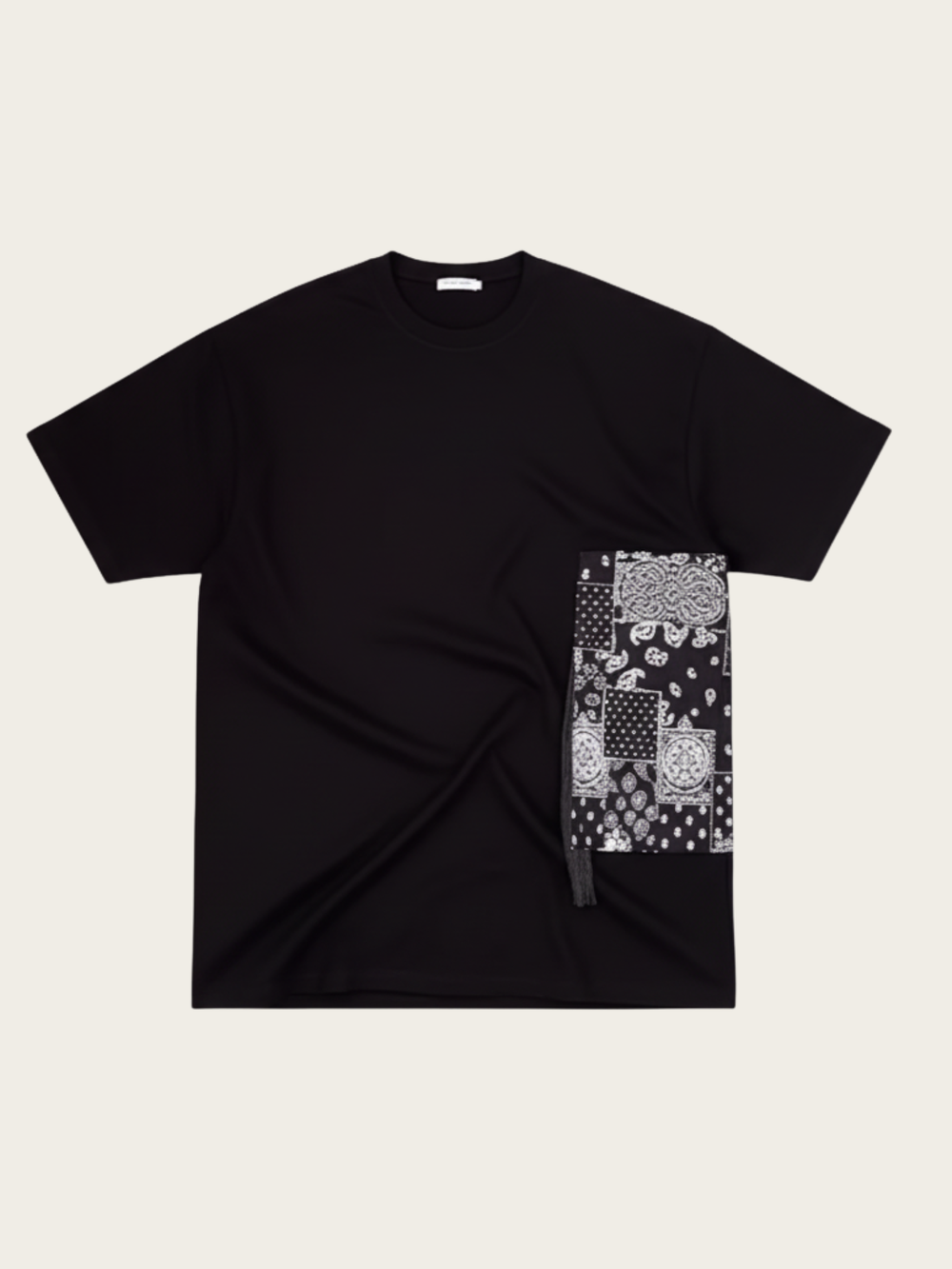 Black t-shirt with a patterned patch on a beige background