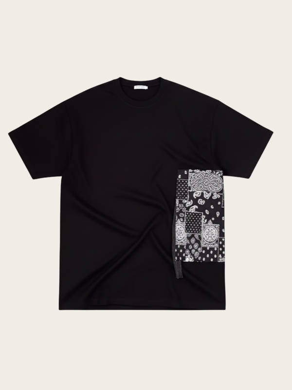 Black t-shirt with a patterned patch on a beige background