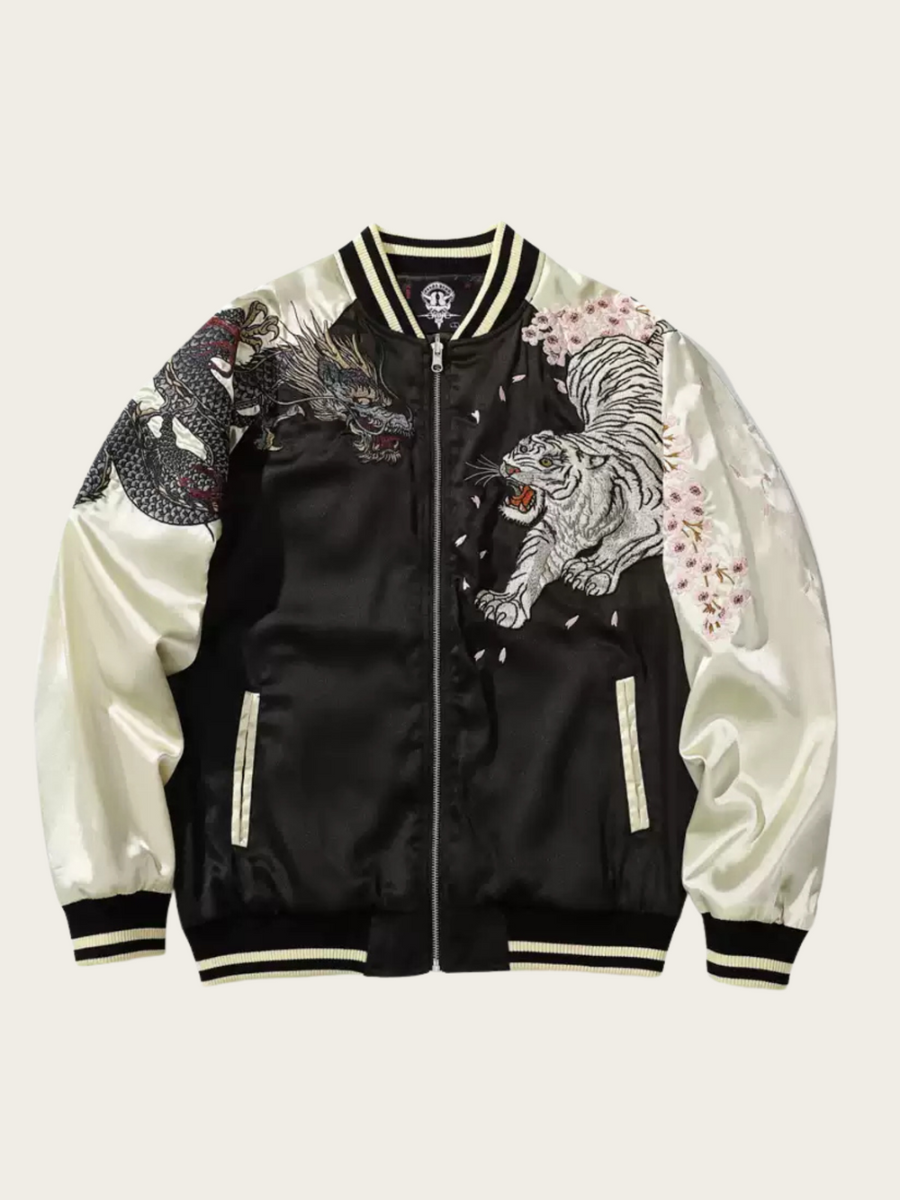 Black and white bomber jacket with dragon and tiger designs on a light gray background