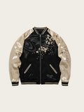 Black bomber jacket with floral embroidery on a beige background