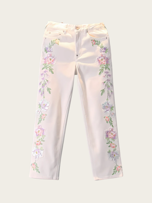 White pants with floral embroidery on a white background