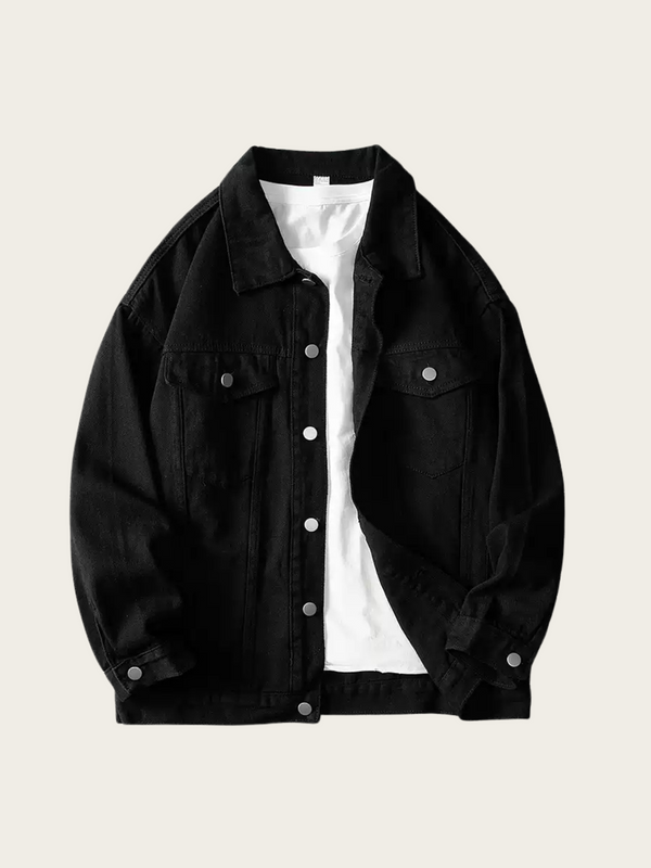 Black denim jacket over a white shirt on a beige background