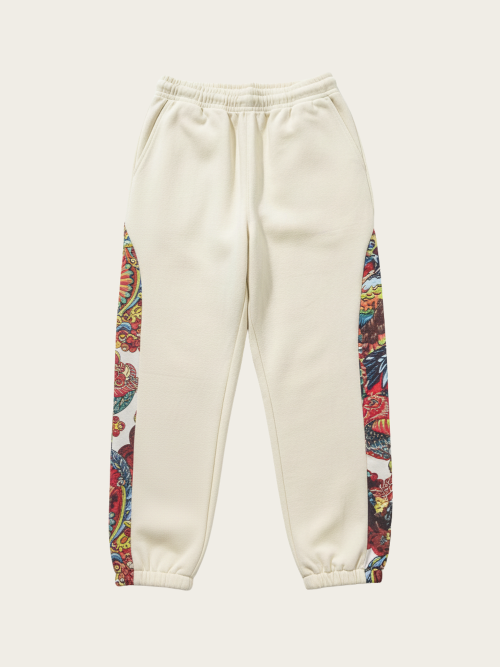 Beige sweatpants with colorful side panels on a white background