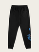 Black sweatpants with blue designs on a beige background