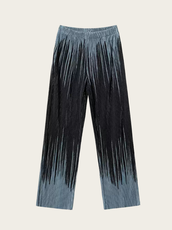 Blue denim pants with black fringe on a beige background