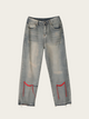 Gray distressed jeans with red accents on a light gray background