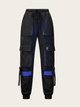 Black cargo pants with blue accents on a beige background