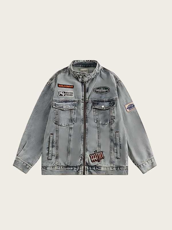 Gray denim jacket with patches on a beige background