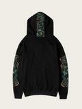 Black hoodie with green and gold embroidery on sleeves and hood against a white background