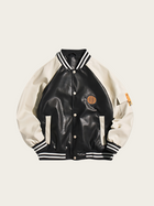 Black and white varsity jacket with a patch on a beige background