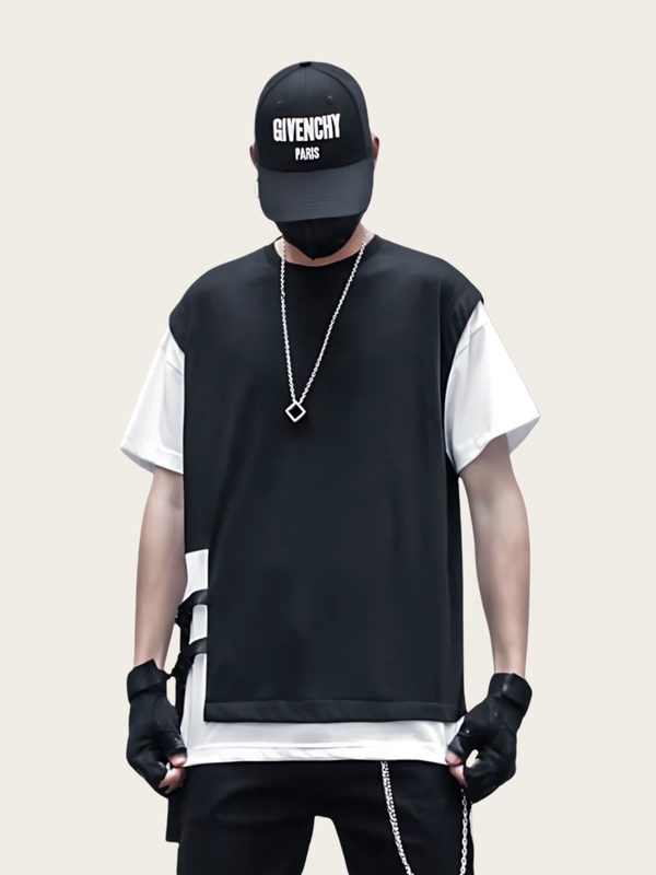 Person wearing a Givenchy cap, black vest, and white shirt on a beige background