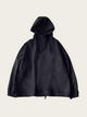 Black hooded jacket on a light beige background