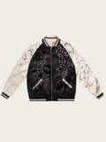 Black and white jacket with intricate designs on a beige background