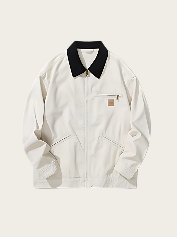White jacket with black collar on a light beige background