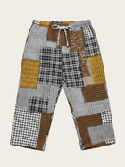 Patchwork patterned pants on a beige background