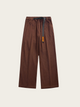 Brown corduroy pants with a belt on a beige background