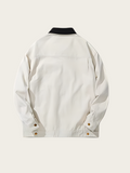 White jacket with black collar on a light beige background