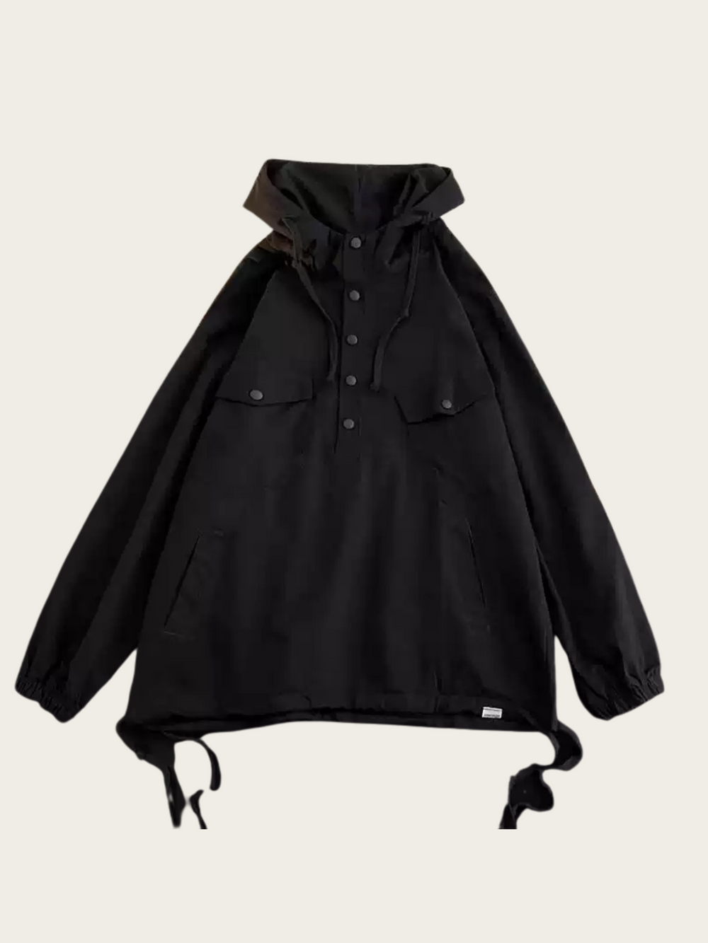 Black jacket with a hood on a beige background