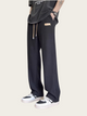 Person wearing black pants with a white background