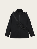 Black jacket with a crossbody bag on a beige background