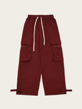 Maroon cargo pants with multiple pockets on a beige background