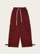 Maroon cargo pants with multiple pockets on a beige background