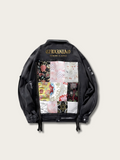 Black jacket with floral patterns and brand name on a beige background
