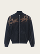 Navy blue jacket with gold lizard embroidery on a beige background