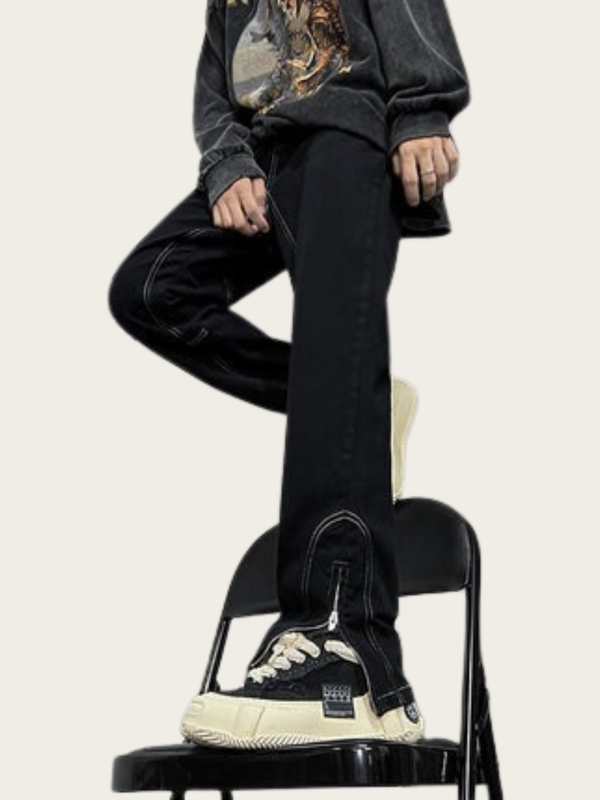 Person wearing black pants and sneakers sitting on a chair with a neutral background