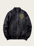 Black jacket with gold tiger emblem on a beige background