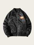 Black bomber jacket with floral embroidery on a beige background