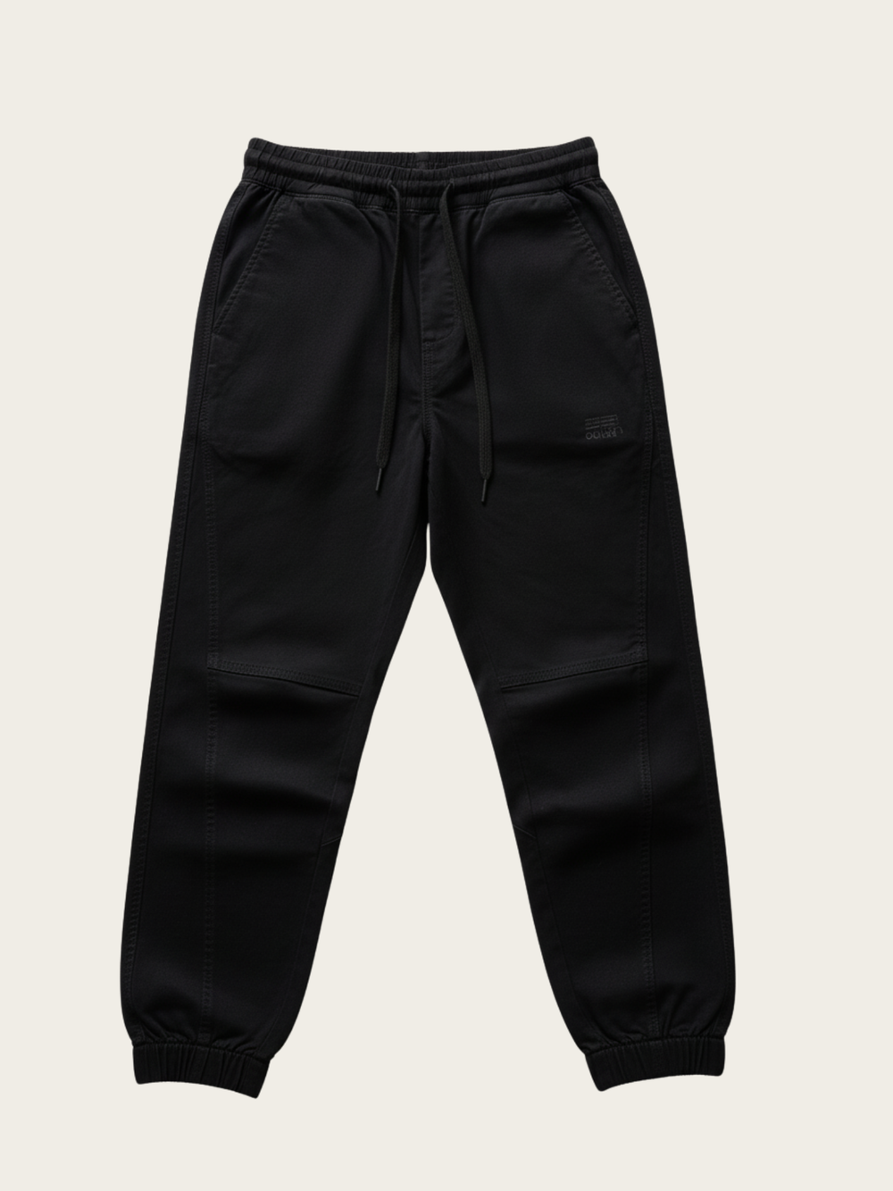 Black jogger pants on a beige background