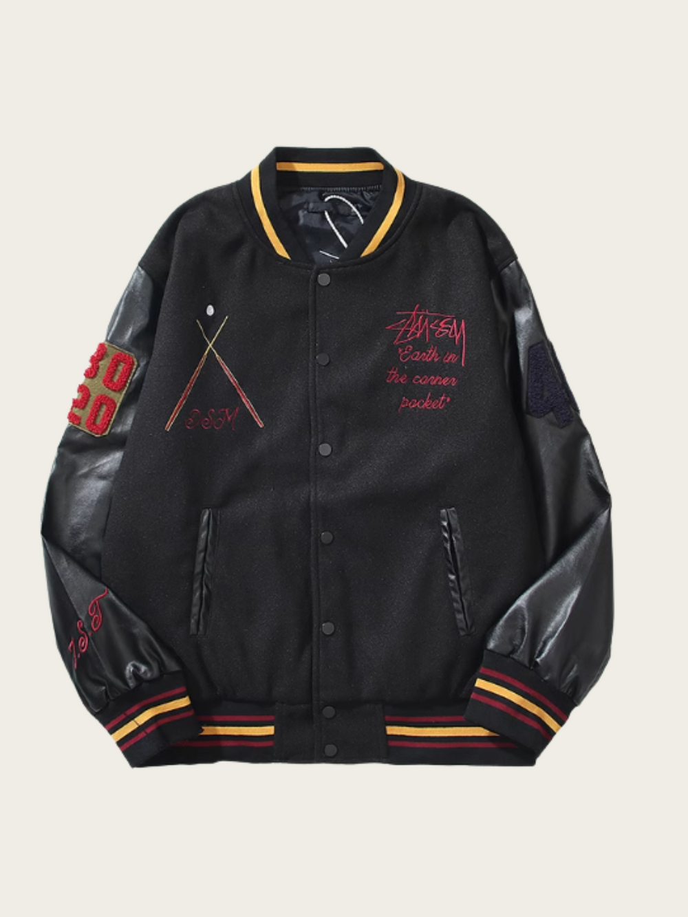 Black varsity jacket with red and yellow accents on a beige background