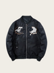 Black jacket with wolf designs on a beige background