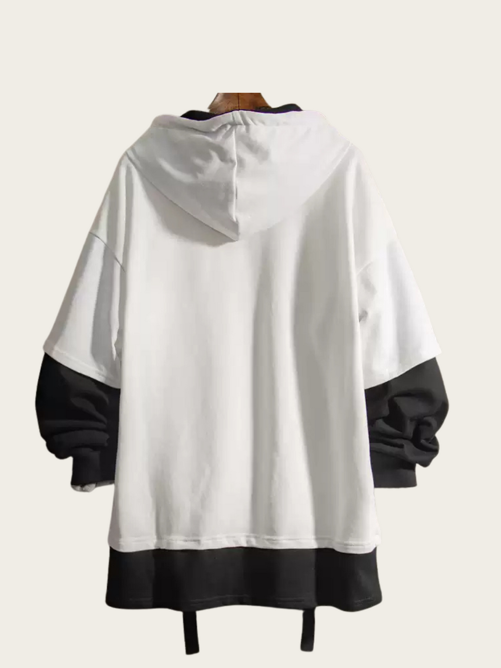 White and black hoodie on a mannequin against a white background