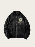 Black bomber jacket with skull design on a beige background