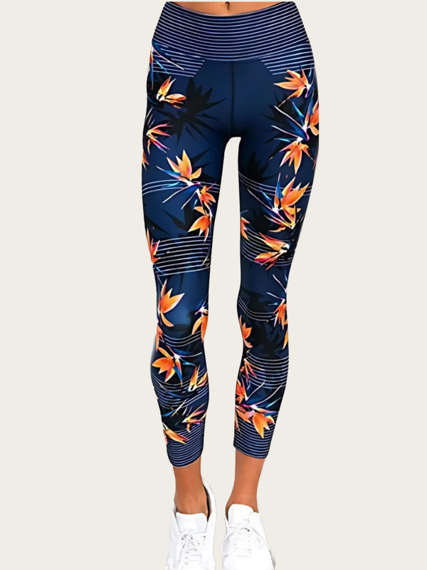 Navy leggings with orange floral pattern worn by a person on a white background