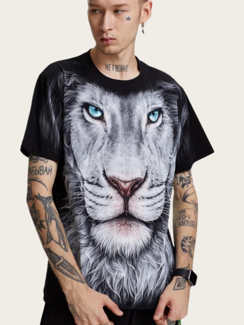 Person wearing a black t-shirt with a graphic of a lion's face on a plain background