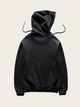 Black hoodie on a light beige background